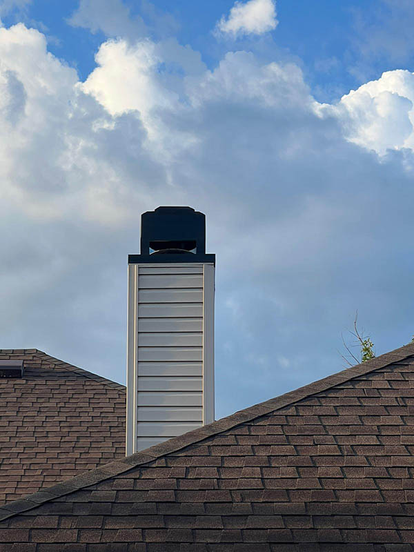 fireplace contractors doing inspection Chimney cap on DFW rooftop