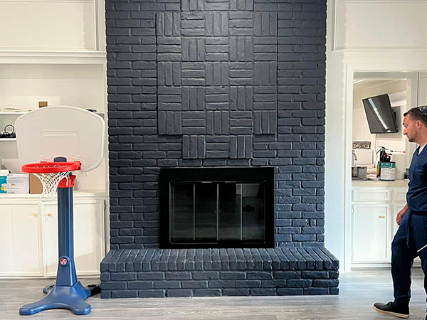 technician by black brick chimney
